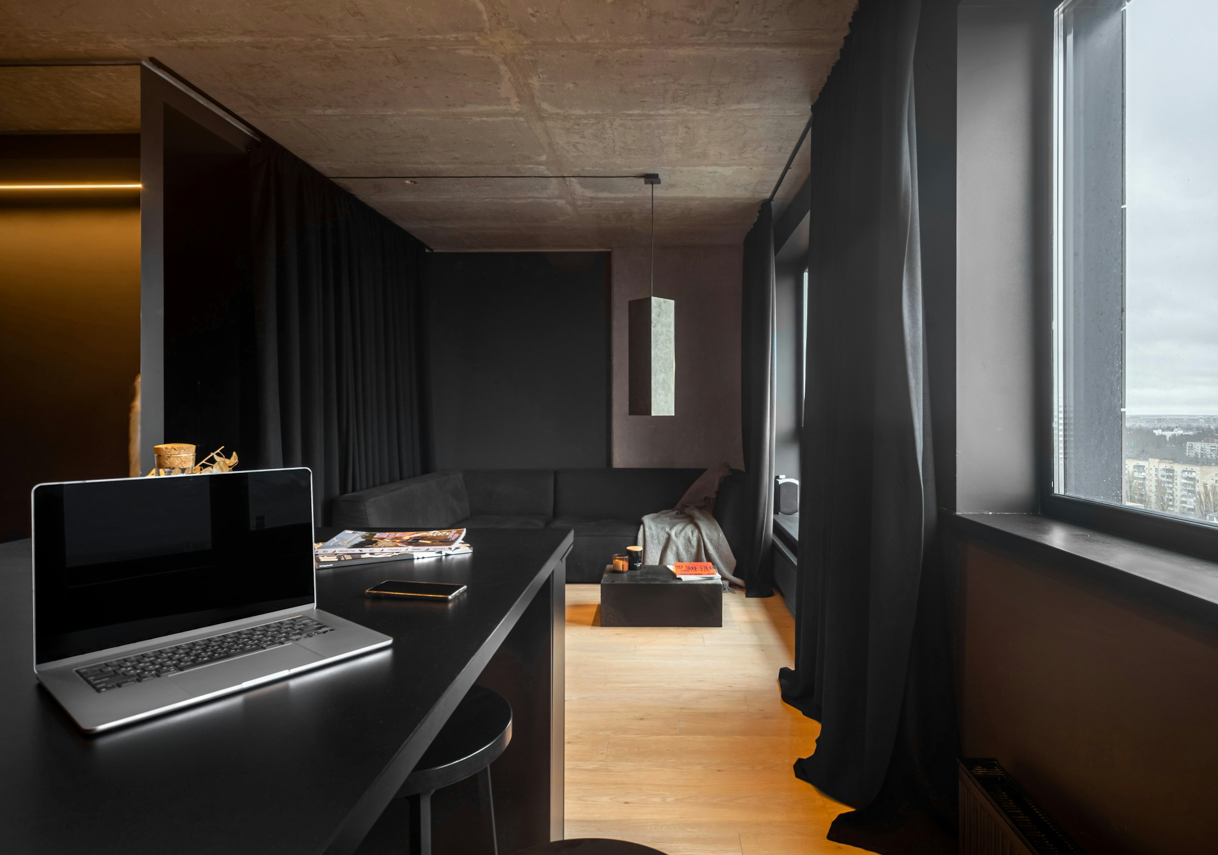 Dark, moody minimalist apartment interior at dusk